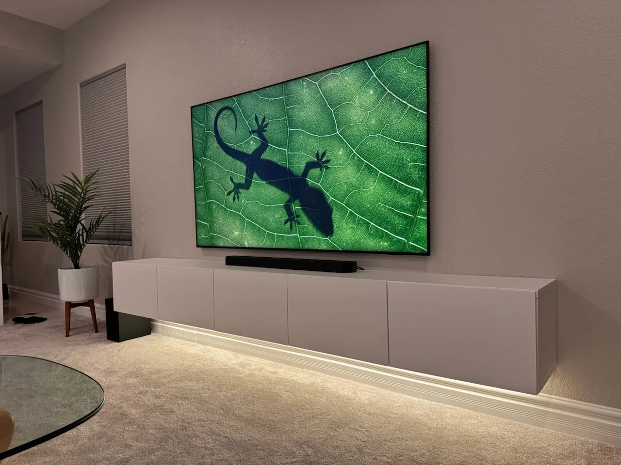 Finished wall-mounted TV with illuminated console after installation