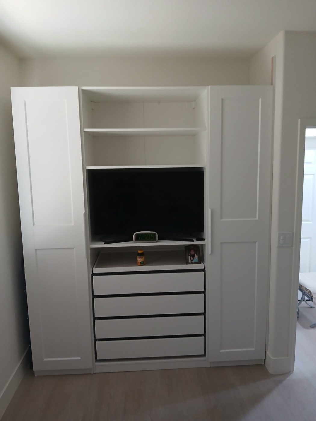 Built-in wardrobe and entertainment unit assembled by Level Up handyman
